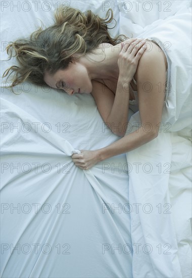 A woman sleeping in bed.