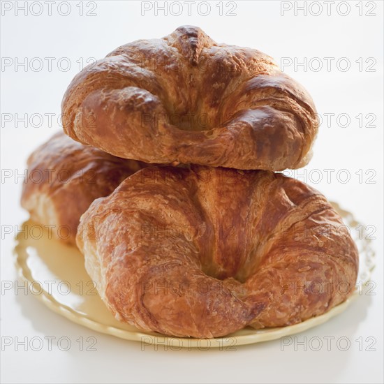 Three croissants on a plate.