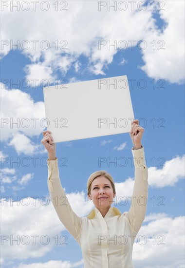 Woman holding a blank sign.