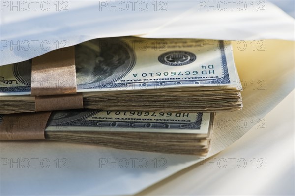 Hundred dollar bills in an envelope