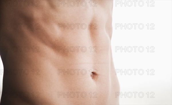 A man's shirtless abdomen