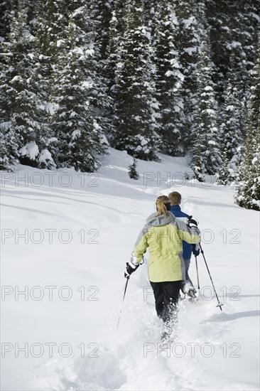 A couple snow shoeing