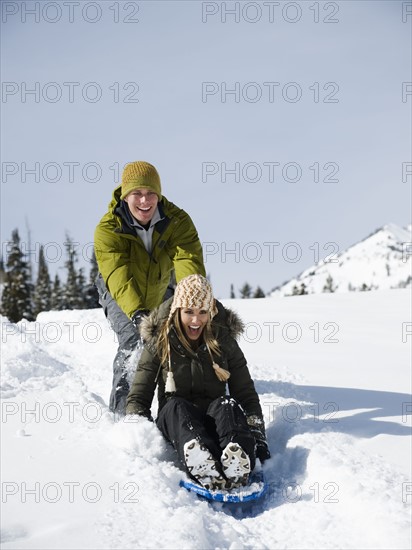 A couple sledding