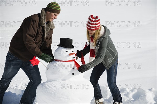 A couple making a snowman