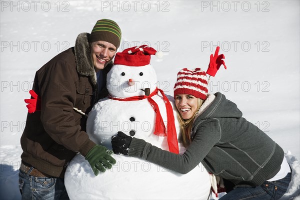 A couple making a snowman