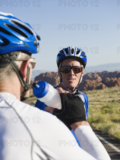 Bikers on the road taking a break drinking water