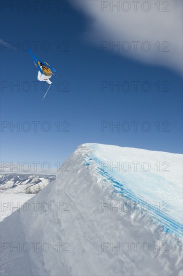 A downhill skier jumping