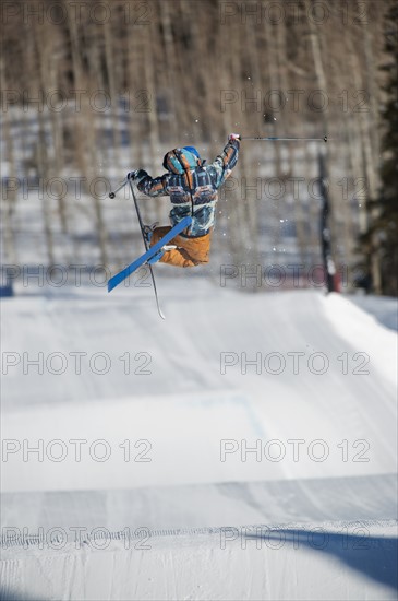 A downhill skier jumping