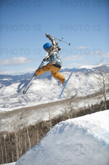 A downhill skier jumping