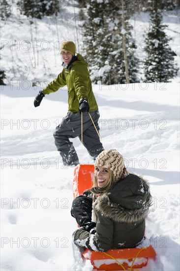 A couple sledding