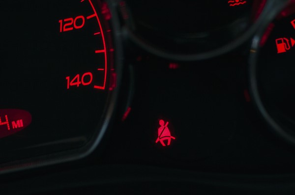 The seat belt warning on the dashboard of a car