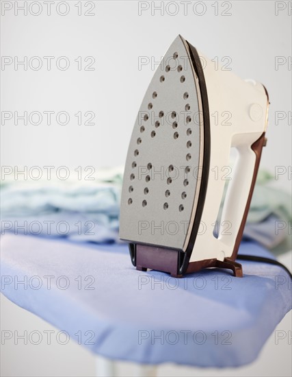 An iron on a ironing board