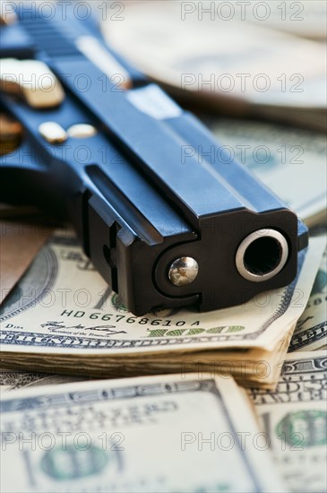 A handgun on stacks of money