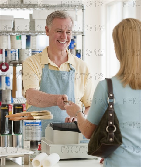 A woman buying paint.