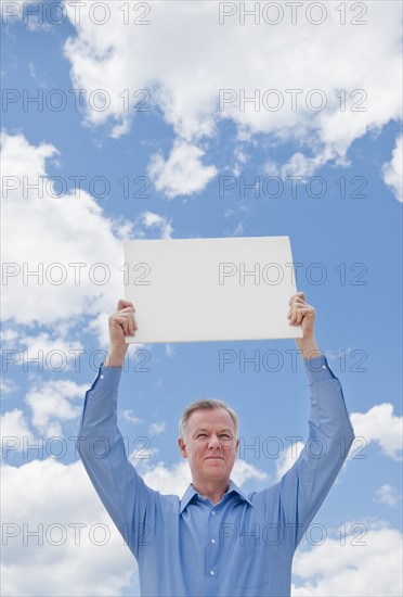 Man holding a blank sign.