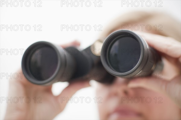 Woman using binoculars.