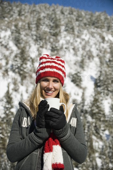 A woman with a mug outdoors