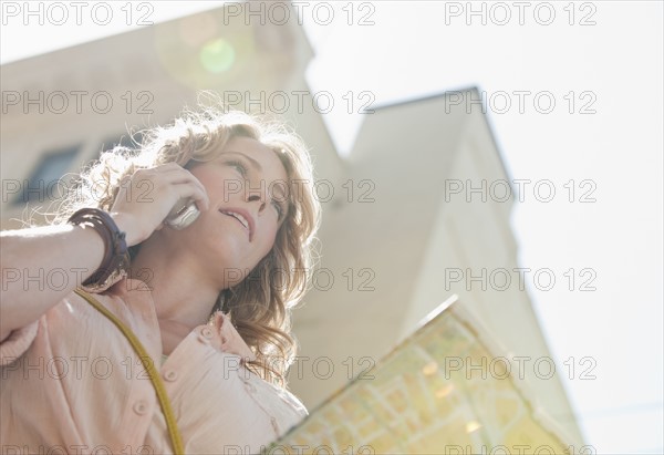 Woman outdoors with a map.