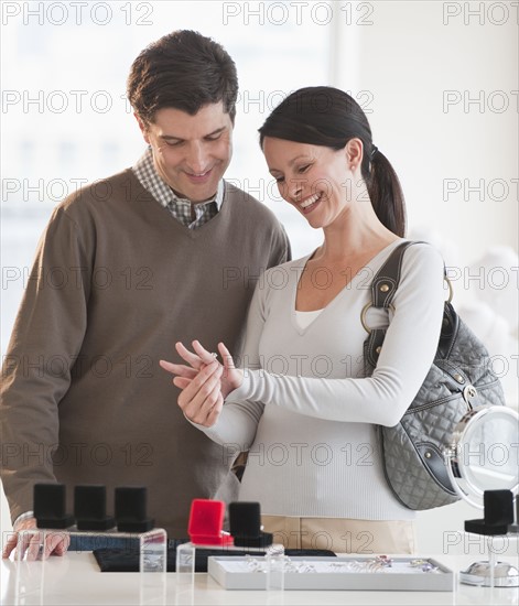 A couple looking at engagement rings.