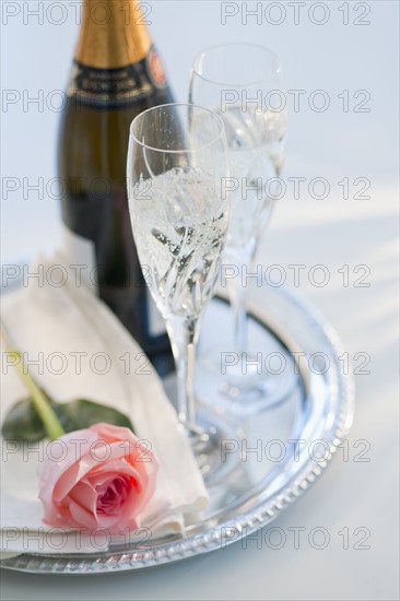 Champagne bottle and rose.