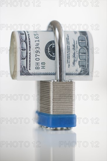 Hundred dollar bills in a padlock.