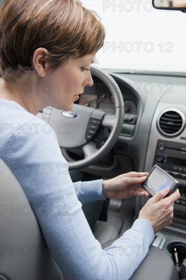 Woman in car with GPS.