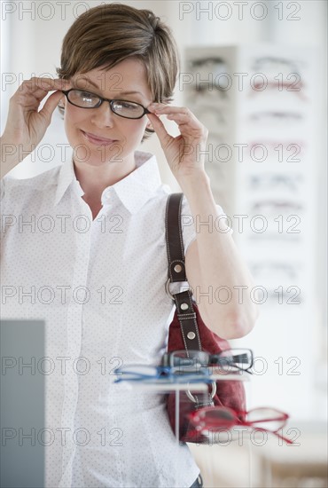 Woman trying on glasses.