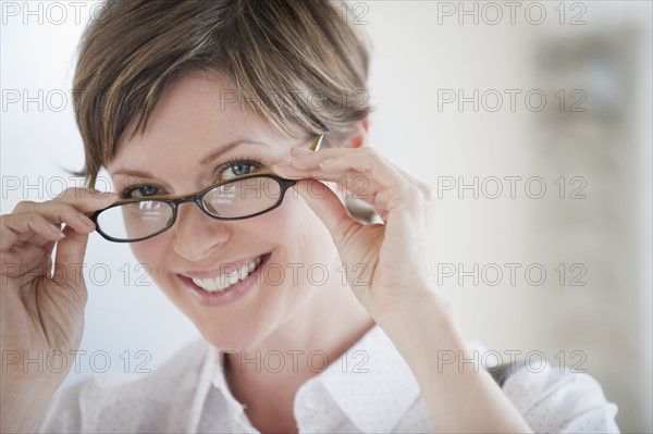 Woman trying on glasses.