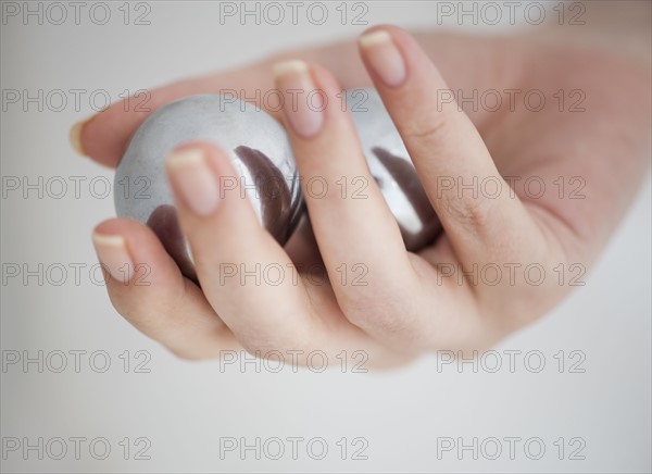 Hand holding Chinese balls.