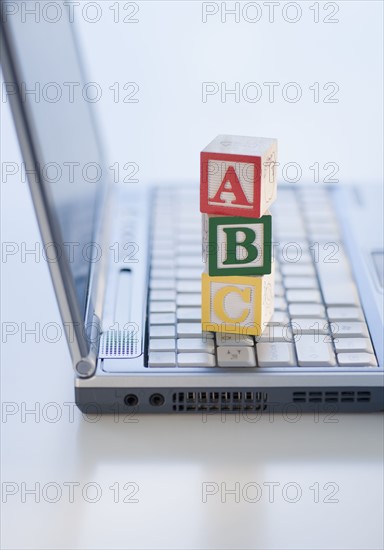 Letter blocks on laptop.