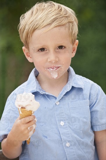 Child eating ice cream cone.