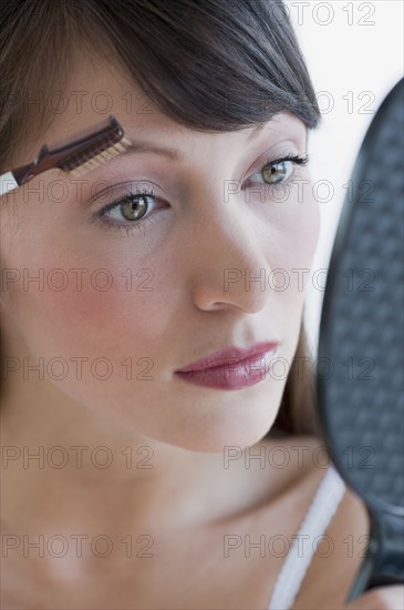 Woman applying makeup.