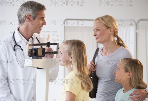 Mother and daughters at Doctor's office.