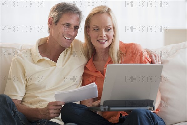 Married couple working on computer.