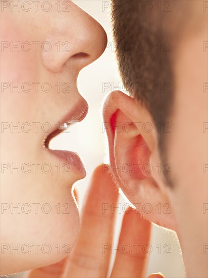 Whispering into ear.