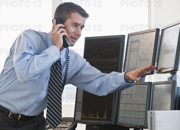 Trader studying computer screens.