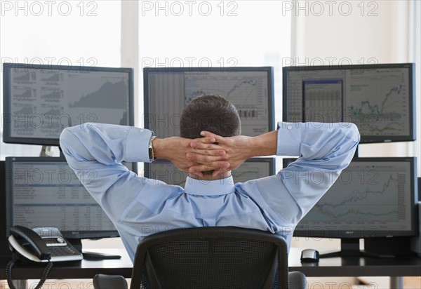 Relaxed male trader at work.