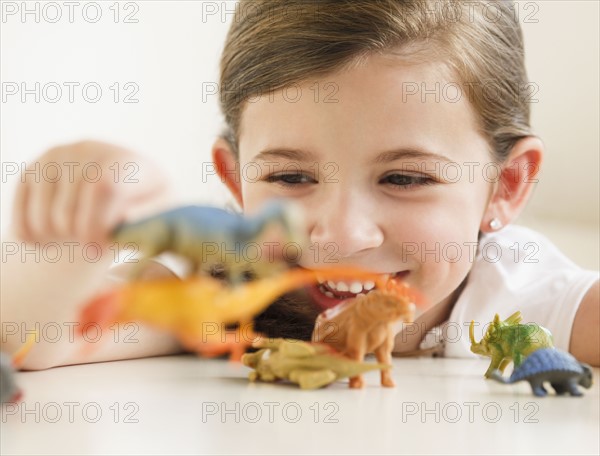 Child playing with dinosaurs