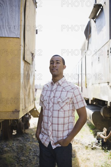 Young man beside train