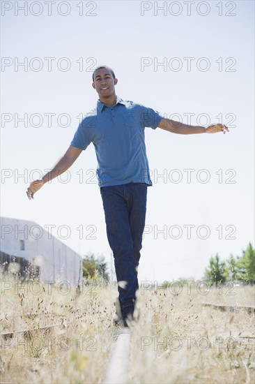 Young man on railroad track