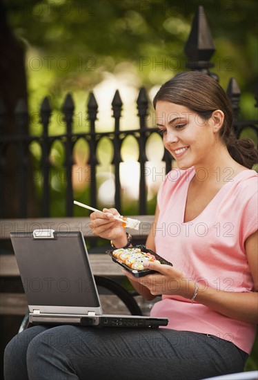 Woman eating Sushi