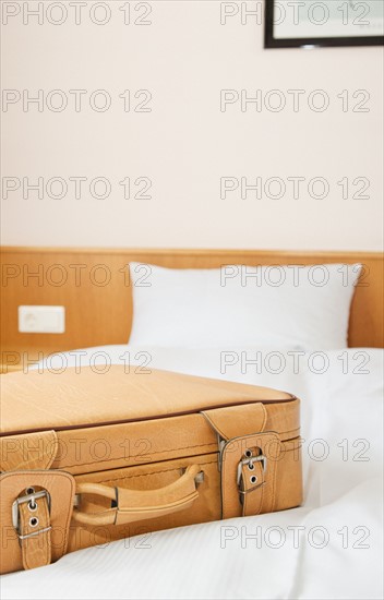 Suitcase on bed