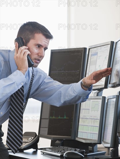 Trader studying computer screens.