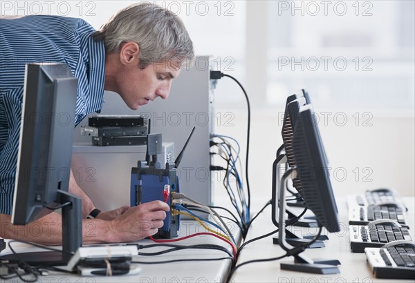 Man with networked computers.