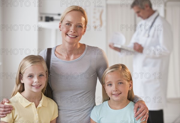 Mother and daughters at Doctor's office.
