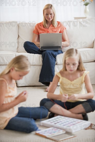 Mother and daughters at home.