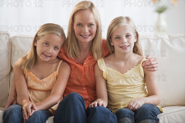 Mother and daughters at home.