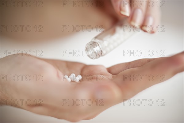 Pills in hand.