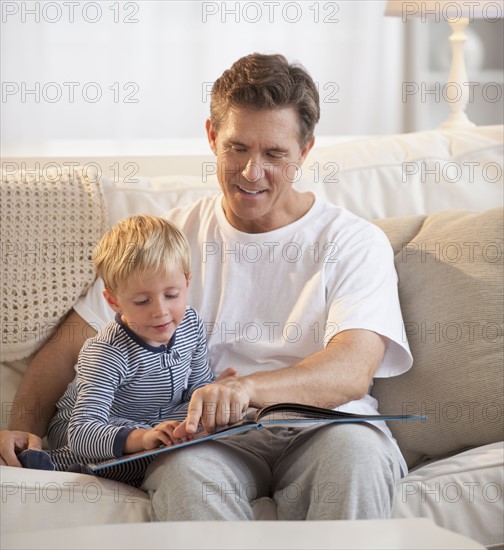 Father teaching child to read.