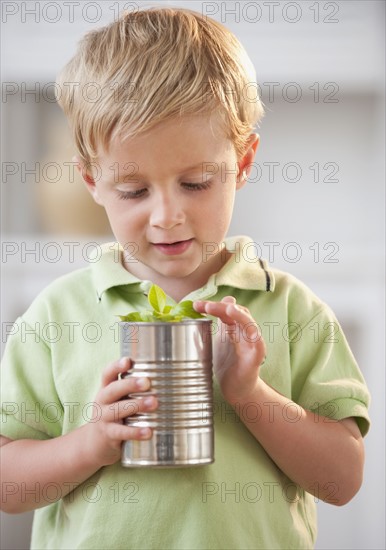 Child examining plant.